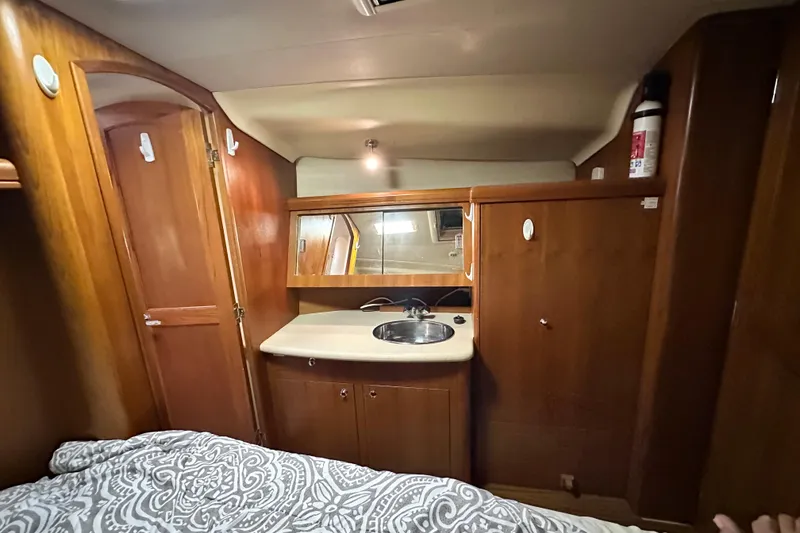 Slide: The Image of Interior of 2006 Hunter 41 Deck Salon with wood cabinetry and sink. - 59