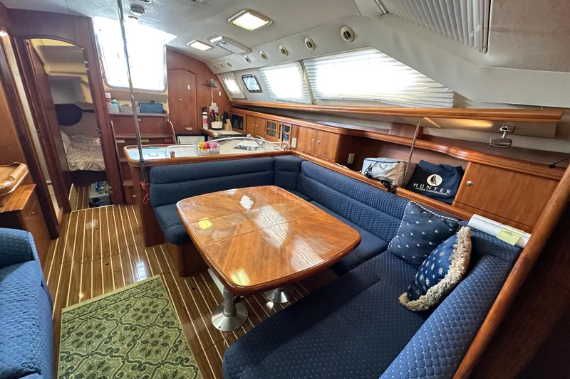 Slide: The Image of Interior of 2006 Hunter 41 Deck Salon with elegant wood finish and cozy seating. - 60