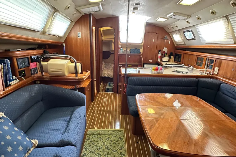 Slide: The Image of Interior of 2006 Hunter 41 Deck Salon yacht with cozy seating and wooden finishes. - 62