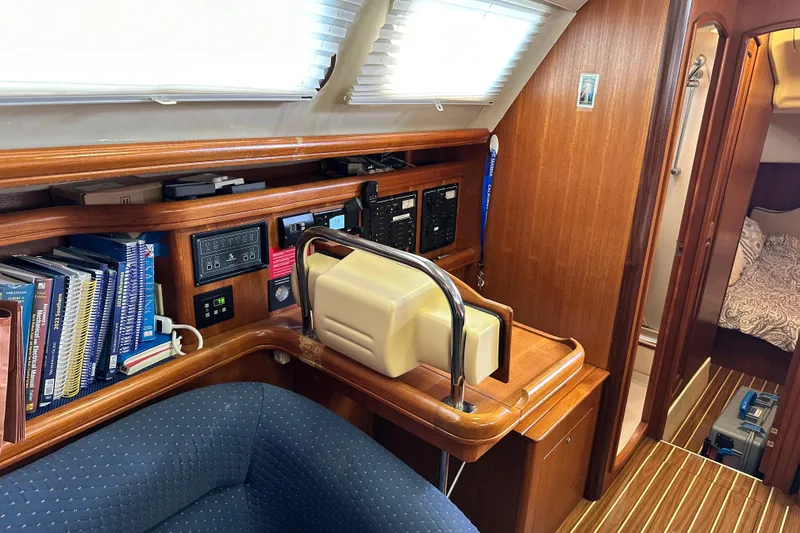 Slide: The Image of 2006 Hunter 41 Deck Salon interior with navigation station and cozy cabin view. - 64