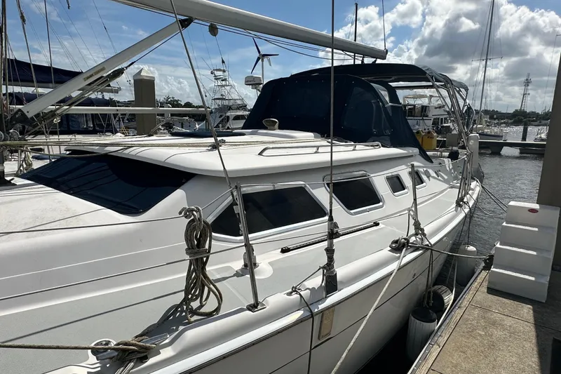 Slide: The Image of 2006 Hunter 41 Deck Salon sailboat docked at marina under sunny skies. - 7
