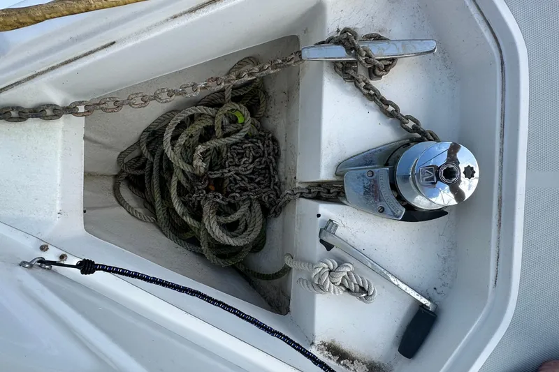 Slide: The Image of Anchor locker of 2006 Hunter 41 Deck Salon with chain, rope, and windlass. - 9