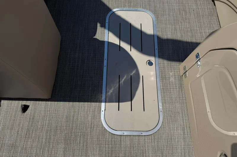 Slide: The Image of 2025 Bentley Pontoons Legacy 243 Navigator deck with storage hatch and textured flooring. - 10