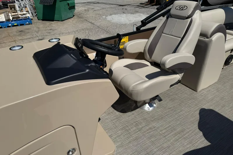 Slide: The Image of 2025 Bentley Pontoons Legacy 243 Navigator helm with beige captain's chair and steering wheel. - 12
