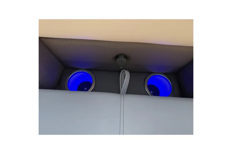 Slide: The Image of 2025 Bentley Pontoons Legacy 243 Navigator interior with illuminated cup holders. - 17