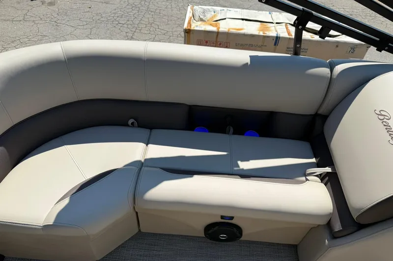 Slide: The Image of 2025 Bentley Pontoons Legacy 243 Navigator interior seating with beige upholstery and cup holders. - 18