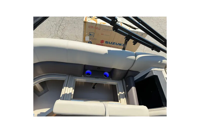Slide: The Image of 2025 Bentley Pontoons Legacy 243 Navigator interior with beige seating and storage compartments. - 19