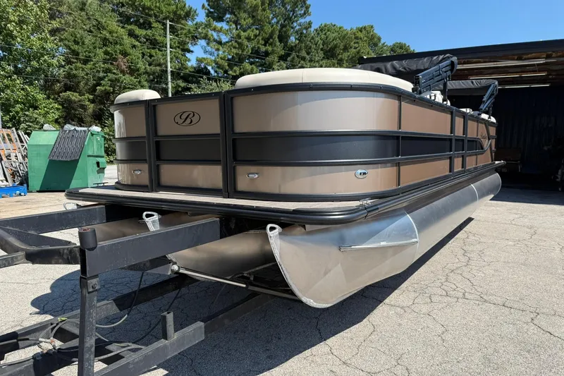 Slide: The Image of 2025 Bentley Pontoons Legacy 243 Navigator on trailer, parked outdoors. - 2