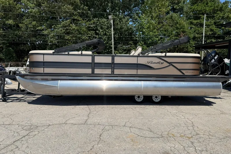 Slide: The Image of 2025 Bentley Pontoons Legacy 243 Navigator on trailer, parked outdoors. - 3