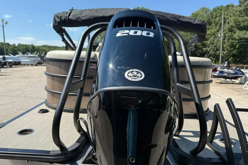 Slide: The Image of 2025 Bentley Pontoons Legacy 243 Navigator with powerful 200 HP engine, docked outdoors. - 4