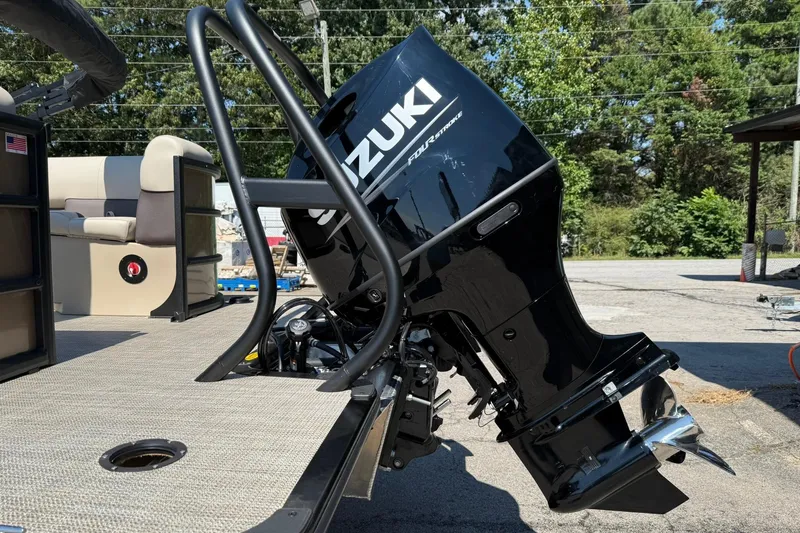 Slide: The Image of 2025 Bentley Pontoons Legacy 243 Navigator with Suzuki outboard motor, docked outdoors. - 6