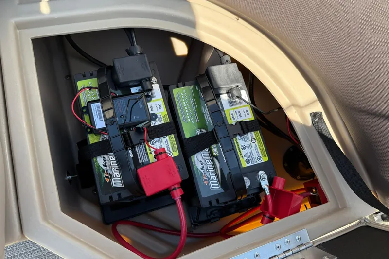 Slide: The Image of Battery compartment of 2025 Bentley Pontoons Legacy 243 Navigator, featuring dual marine batteries. - 8