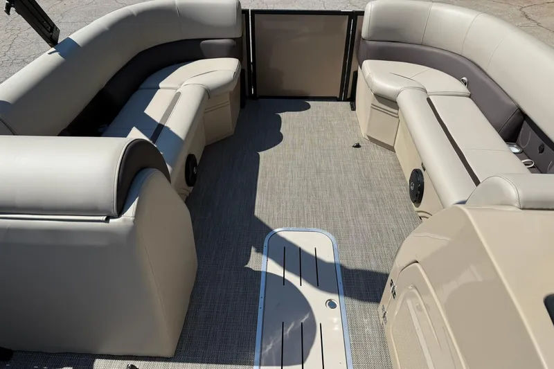 Slide: The Image of 2025 Bentley Pontoons Legacy 243 Navigator interior with beige seating and spacious layout. - 9