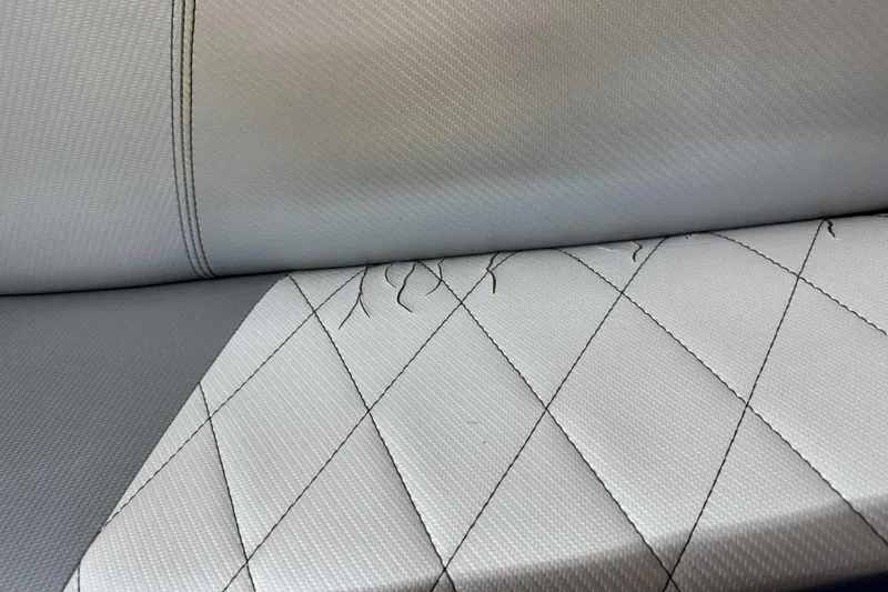 Slide: The Image of 2011 MasterCraft X2 boat seat with visible stitching and wear. - 11