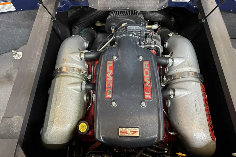 Slide: The Image of 2011 MasterCraft X2 engine featuring Ilmor V8 5.7 components in a boat compartment. - 12