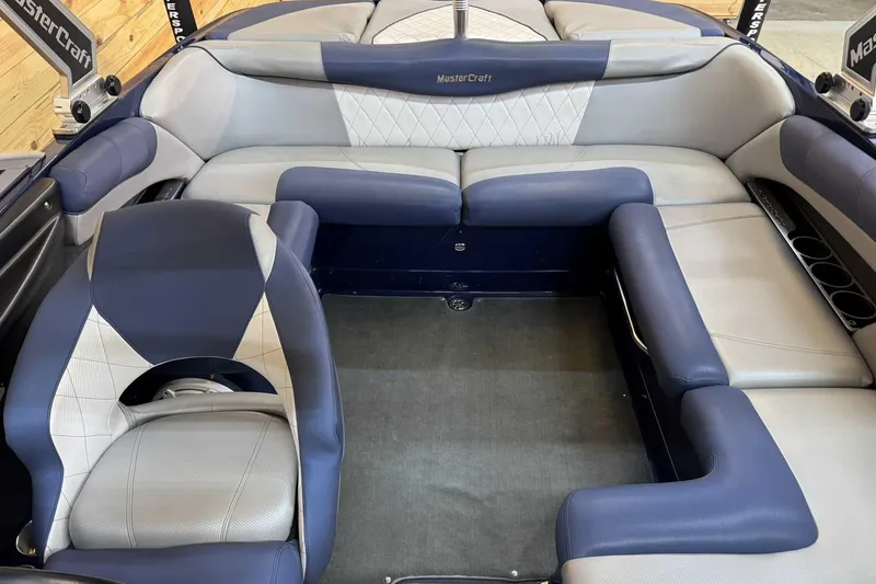 Slide: The Image of 2011 MasterCraft X2 boat interior with blue and gray seating arrangement. - 9
