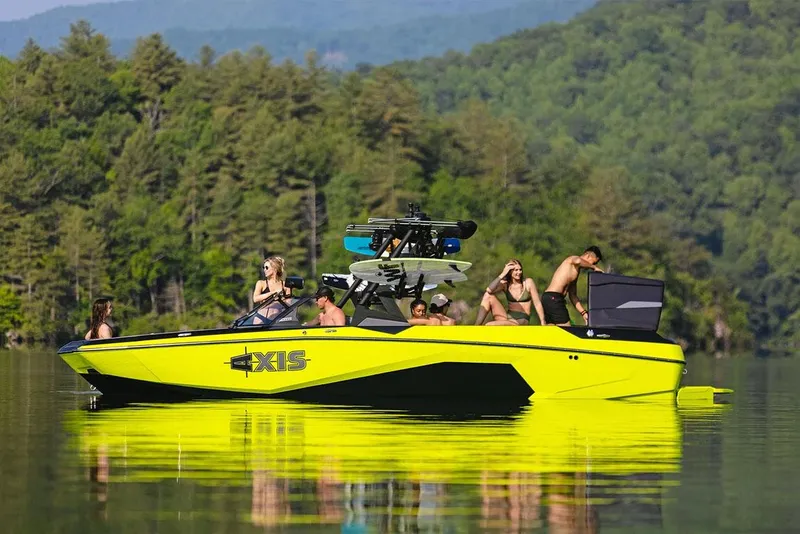 Slide: The Image of Manufacturer Provided Image: 2026 Axis A245 boat on a lake with people enjoying the scenery. - 2