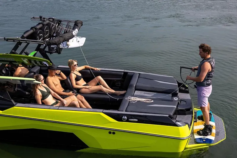 Slide: The Image of Manufacturer Provided Image: 2026 Axis A245 boat with people relaxing and preparing for water sports. - 3