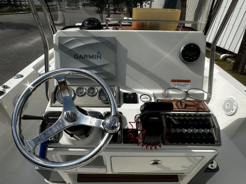 Slide: The Image of 2018 Triton 220LTS boat dashboard with Garmin navigation system and steering wheel. - 4
