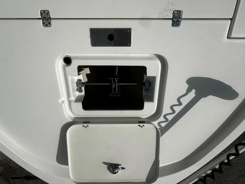 Slide: The Image of 2018 Triton 220LTS boat compartment with open hatch and shadow. - 9