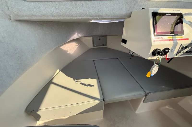 Slide: The Image of 2024 Defiance Admiral 220 EX cabin interior with cushioned seating and control panel. - 5