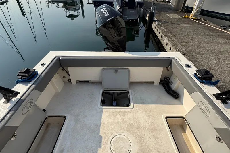 Slide: The Image of 2024 Defiance Admiral 220 EX boat interior with seating and storage compartments. - 7