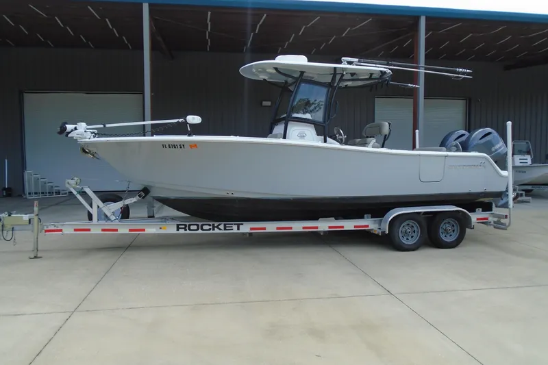 The Image of 2021 Sportsman Open 252 Center Console boat on trailer in storage facility. - 0