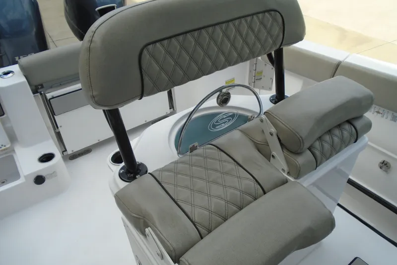Slide: The Image of 2021 Sportsman Open 252 Center Console boat interior with cushioned seating. - 11
