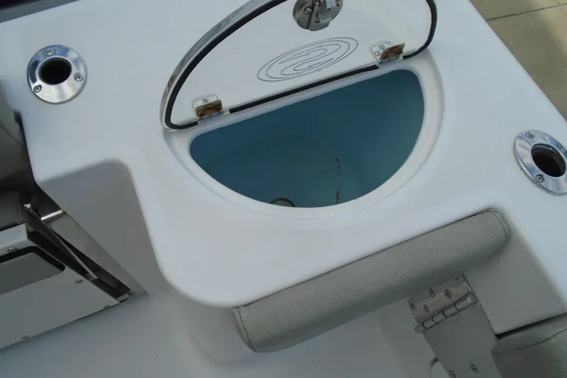 Slide: The Image of 2021 Sportsman Open 252 Center Console boat livewell with open lid and rod holders. - 13