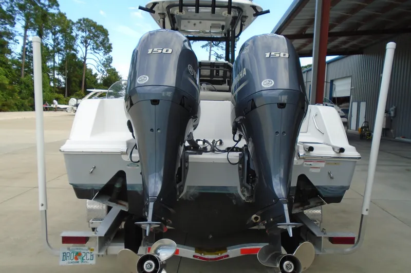 Slide: The Image of 2021 Sportsman Open 252 Center Console with dual Yamaha 150 engines, rear view. - 2