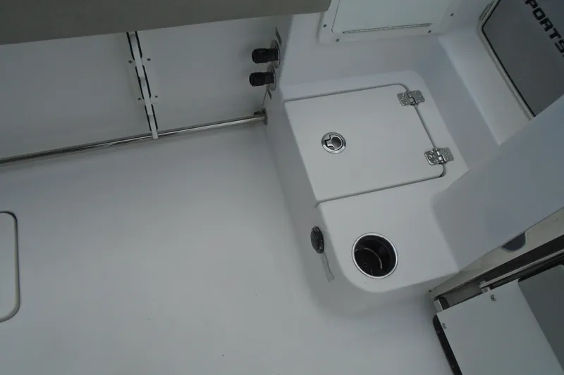 Slide: The Image of 2021 Sportsman Open 252 Center Console interior with storage compartment and cup holder. - 21