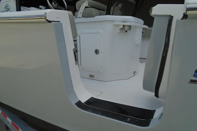 Slide: The Image of 2021 Sportsman Open 252 Center Console boat interior, featuring seating and storage area. - 24