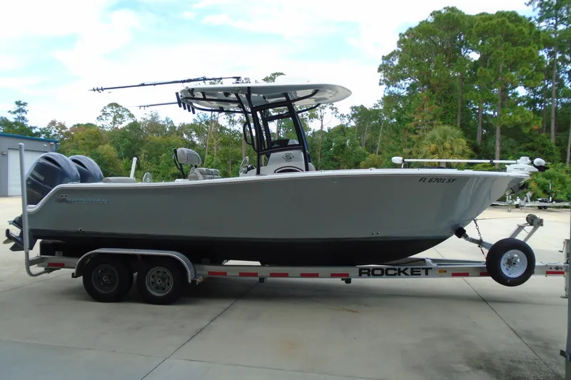 Slide: The Image of 2021 Sportsman Open 252 Center Console boat on trailer, parked outdoors. - 3