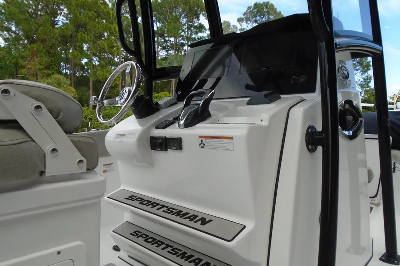 Slide: The Image of 2021 Sportsman Open 252 Center Console boat interior with steering wheel and controls. - 6