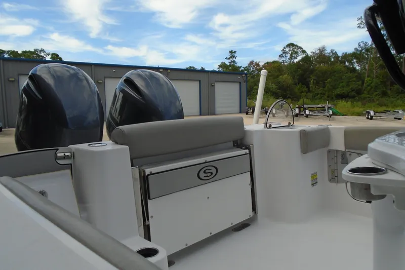 Slide: The Image of 2021 Sportsman Open 252 Center Console boat with dual engines, docked outdoors. - 7