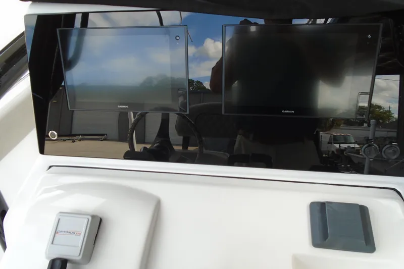 Slide: The Image of 2021 Sportsman Open 252 Center Console dashboard with dual Garmin displays. - 9