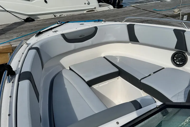 Slide: The Image of 2025 Chaparral 250 OSX boat interior with cushioned seating and speaker. - 6
