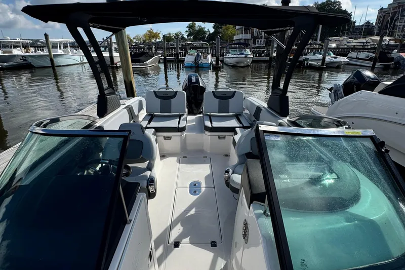 Slide: The Image of 2025 Chaparral 250 OSX boat interior at marina, featuring sleek seating and modern design. - 7