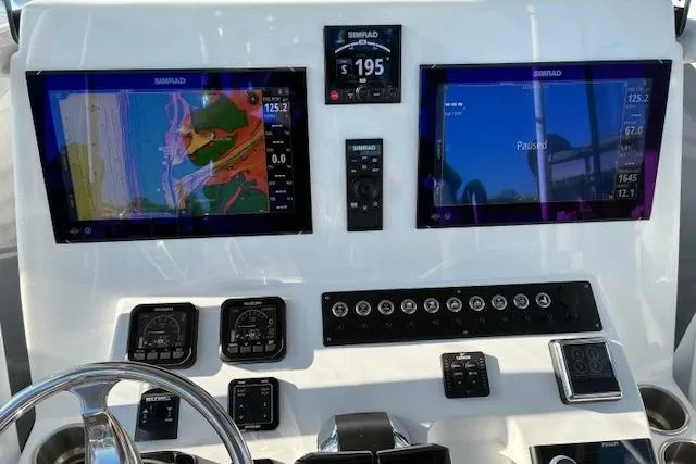 Slide: The Image of 2024 Cape Horn 34 XS boat dashboard with advanced navigation displays and controls. - 12