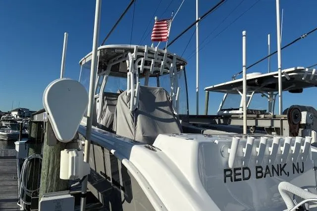 Slide: The Image of 2024 Cape Horn 34 XS boat docked in Red Bank, NJ, with American flag. - 2