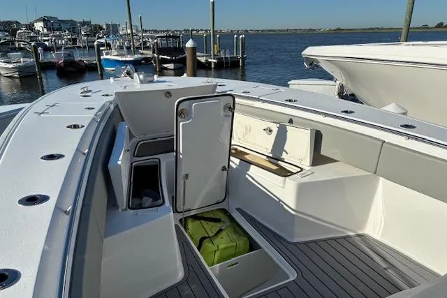Slide: The Image of 2024 Cape Horn 34 XS boat interior with open storage compartments at marina. - 11