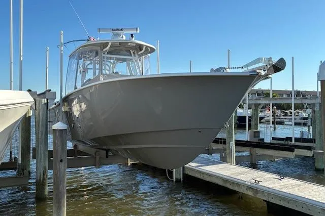 Slide: The Image of 2024 Cape Horn 34 XS boat docked at marina under clear blue sky. - 3