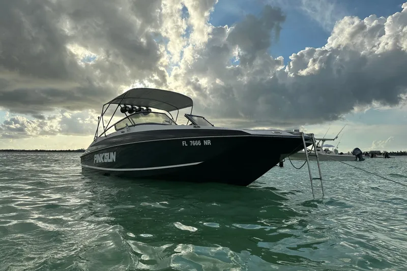 Slide: The Image of 2008 Regal 2520 FasDeck boat on water under cloudy sky. - 10
