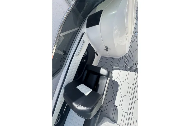 Slide: The Image of 2008 Regal 2520 FasDeck interior with black seat and patterned flooring. - 21