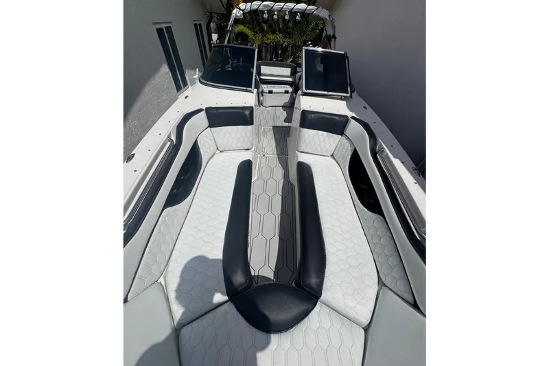 Slide: The Image of 2008 Regal 2520 FasDeck boat interior with white and black seating, hexagonal pattern design. - 23