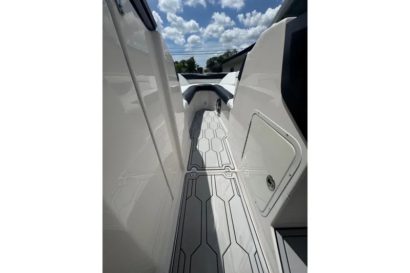 Slide: The Image of 2008 Regal 2520 FasDeck boat interior with sleek flooring and modern design under a sunny sky. - 25