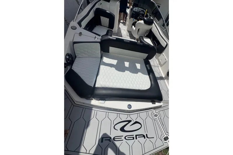 Slide: The Image of 2008 Regal 2520 FasDeck boat interior with black and white seating and logo. - 35