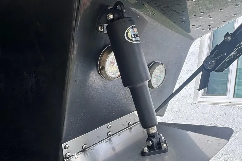 Slide: The Image of Close-up of 2008 Regal 2520 FasDeck boat trim tab and hydraulic actuator. - 38