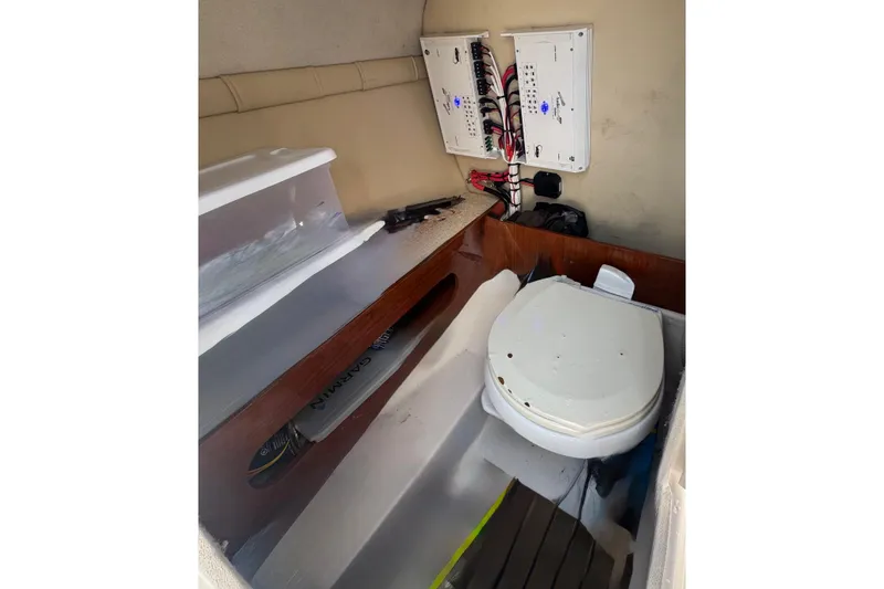 Slide: The Image of 2008 Regal 2520 FasDeck boat interior with toilet and electrical panels. - 43