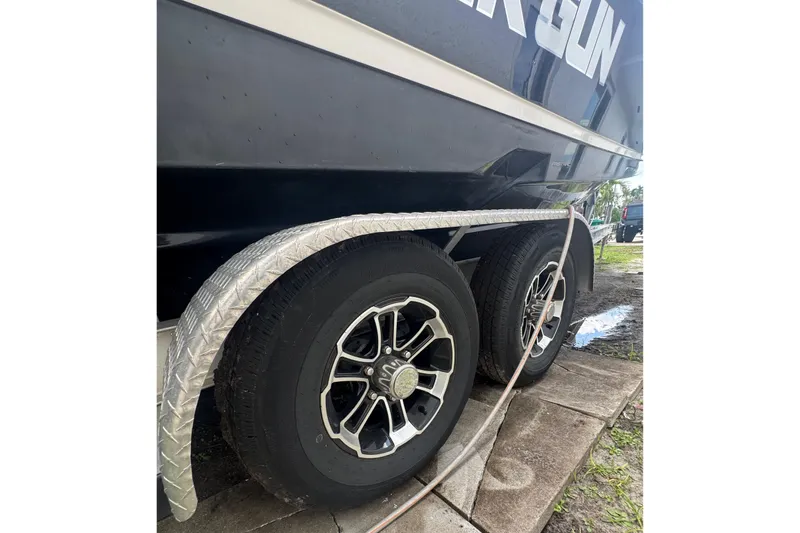 Slide: The Image of Trailer wheels of a 2008 Regal 2520 FasDeck boat on pavement. - 44